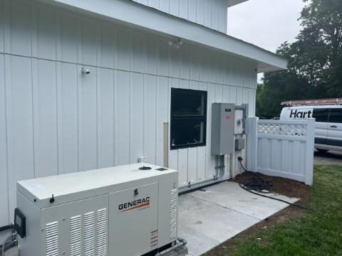 Generac liquid-cooled standby generator installed beside a Hampton Roads home