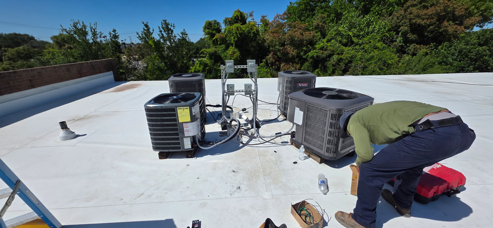 Hart Electric technician servicing rooftop equipment in Norfolk